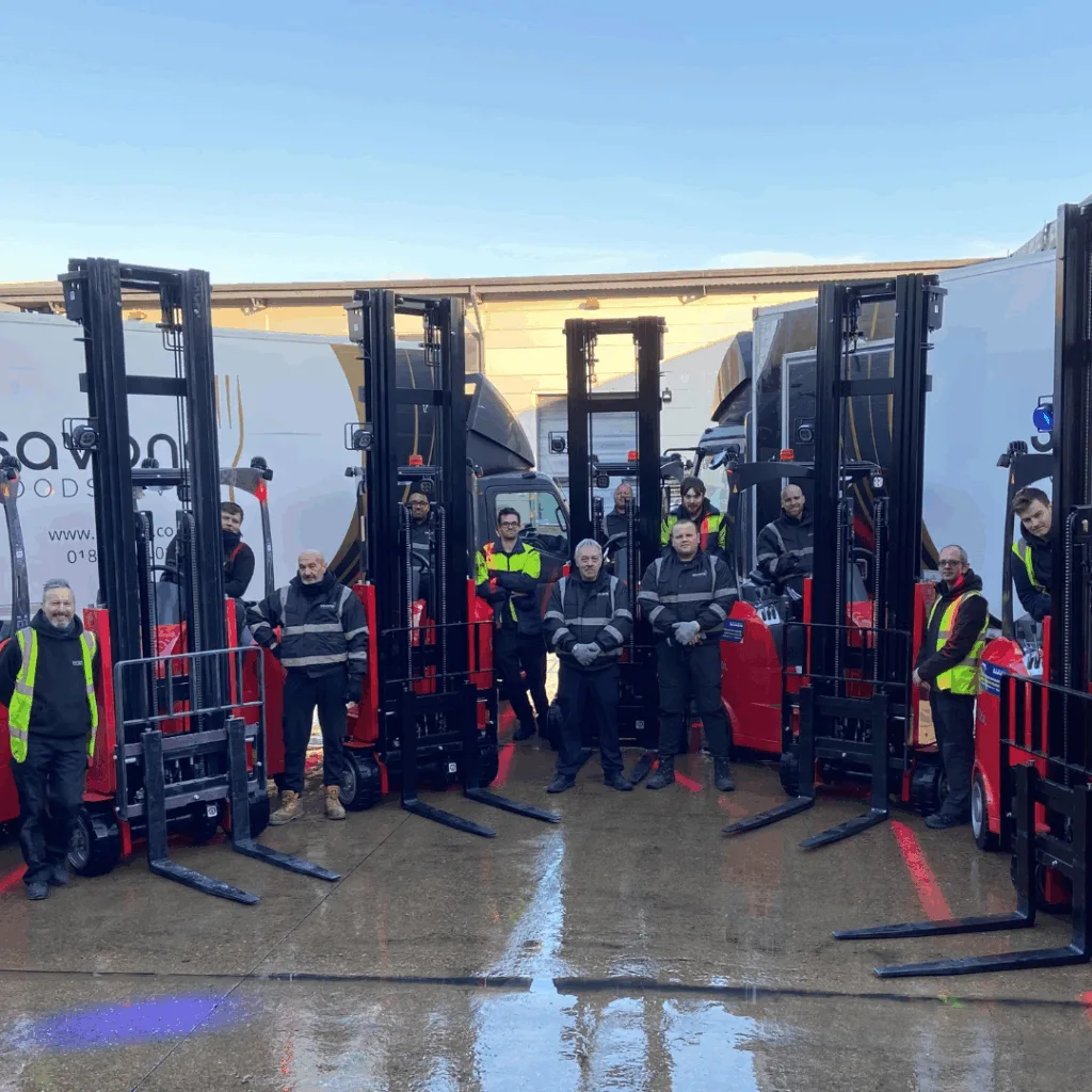 Warehouse workers next to fork lifts