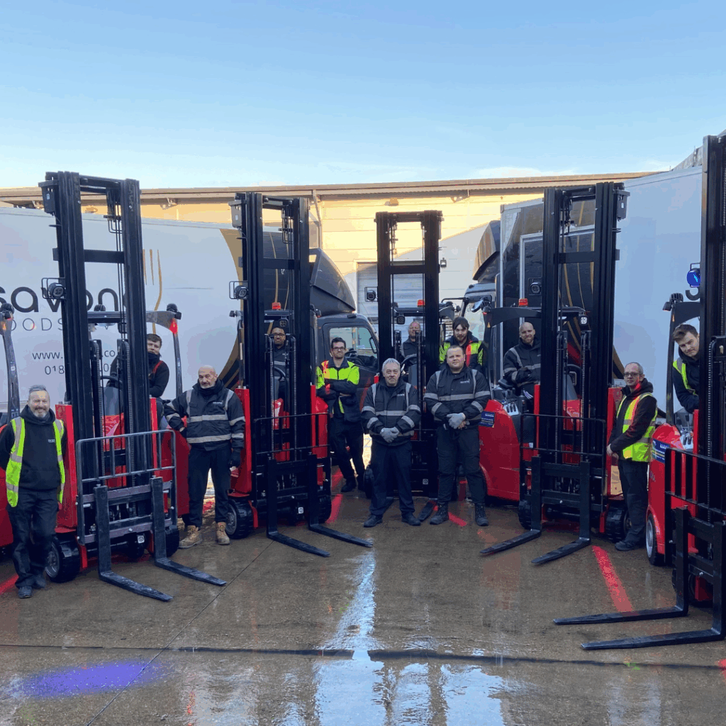 Warehouse workers next to fork lifts