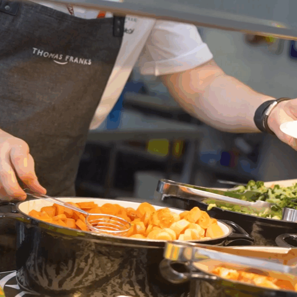 Thomas Franks chef serving dish over counter