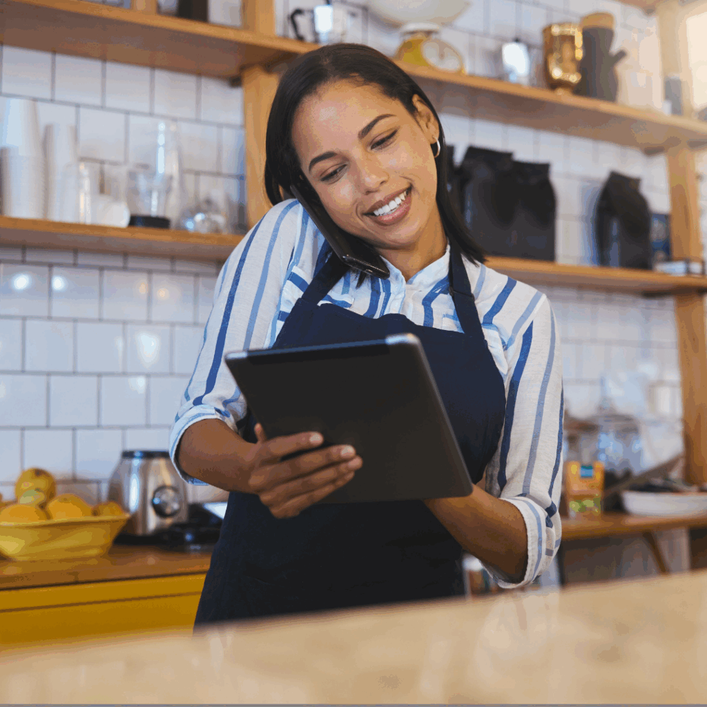 Female barista, cafe worker on ipad ordering supplies